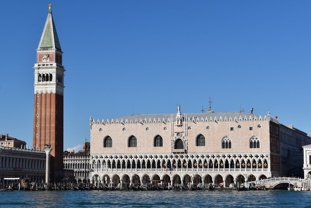 Exterior facade of the Doge's Palace in Venice showing Gothic arched colonnade and pink marble walls