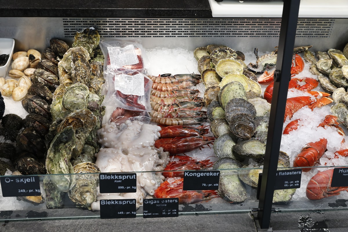 Fresh seafood displayed on ice at the Rialto fish market with vendors in the background