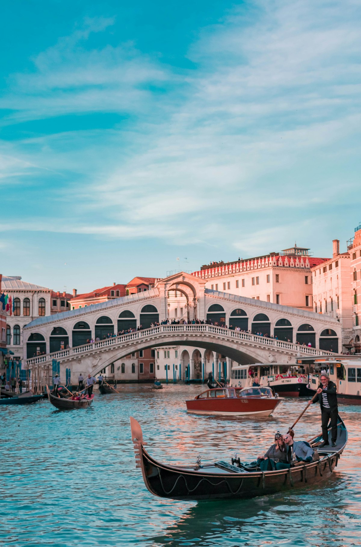 Rialto Bridge spanning the Grand Canal with its distinctive stone arches and covered walkway